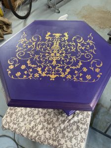 Ethan Allen Purple six sided table with gold transfer on top and gold legs.  